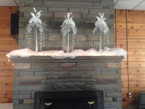 Stone fireplace with winter silver decorations and pine wall