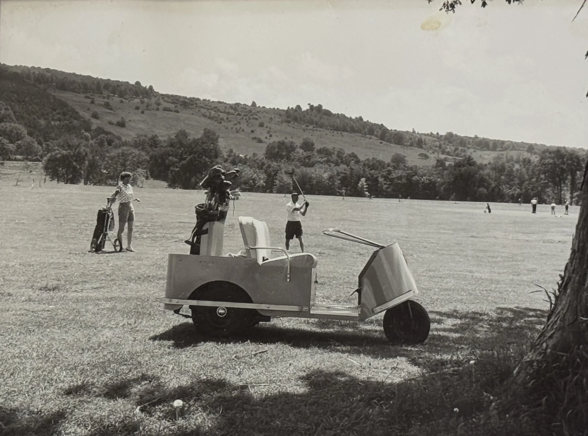 Vintage 1955 black and white photo of golfers with motorized cart on the original Genegantslet course