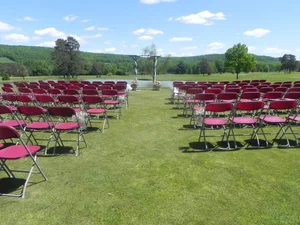 Red ceremony chairs with mountain ridge and blue sky