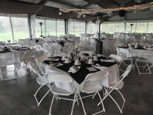 Black tablecloth and silver accent pavilion wedding setup