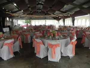 Coral chair sashes and white covers in the pavilion